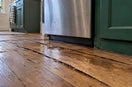 Cupped hardwood boards with water at seams